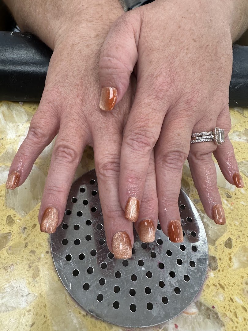 Manicured hands with glossy nail polish